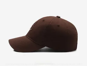 Side view of dark brown baseball cap featuring high-density cotton and detailed embroidery
