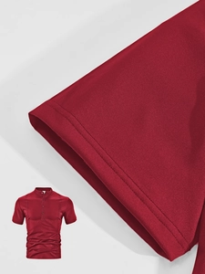 Detail of short sleeve cuff and vertical pleat on dark red cotton polo shirt