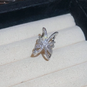 Macro view of a silver minimalist ring with micro-pave cubic zirconia in a butterfly shape