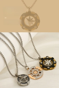 Detail of nautical compass and ship wheel pendants in silver, gold, and black steel