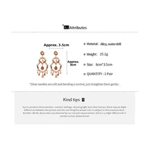 Detailed view of bohemian teardrop earrings with pink rhinestones and 8x3.5cm dimensions