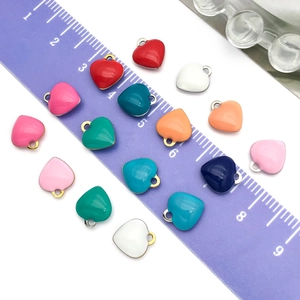 Colorful stainless steel heart pendants for DIY jewelry making shown with a ruler