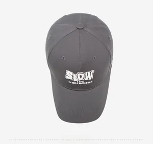 Close-up of charcoal grey baseball cap with white SLOW LIFE embroidered text detail