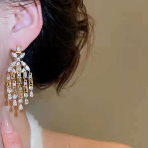 Elegant drop earrings with square and teardrop champagne zircons on gold-plated metal