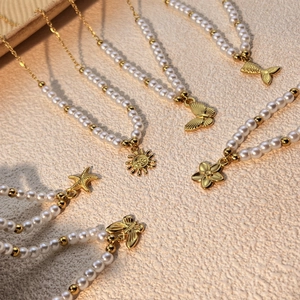 Fashionable stainless steel pearl necklaces with gold starfish, sun and flower pendants