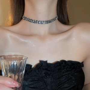 Close-up of a silver-toned choker necklace with sparkling cubic zirconia on a model