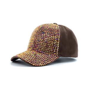 Close-up of sparkling gold rhinestones on a brown baseball cap with detailed craftsmanship