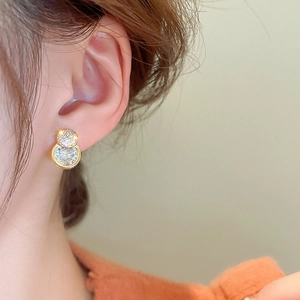 Elegant gold plated double circle stud earrings with sparkling cubic zirconia on female model