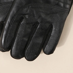 Close-up of black PU leather gloves showing detailed lychee texture and fabric stitching