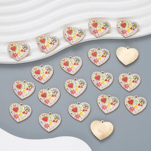 Detail of heart eye enamel pendants with gold metal plating and colorful patterns