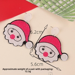 Close-up of glittery acrylic Santa Claus drop earrings with red hat and white beard detail