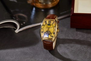 Detailed macro view of gold tonneau case with sun and moon phase on luxury watch face