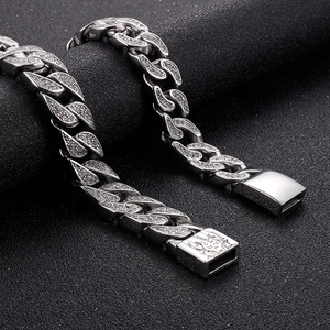 Macro shot of silver iced-out Cuban chain with lion head relief on the buckle