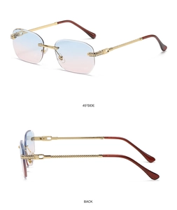 Detail of rimless vintage sunglasses with blue-pink gradient lenses and diamond accents