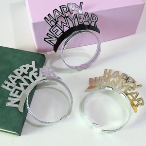 Close-up of Happy New Year headbands in gold, silver and black with festive gift styling