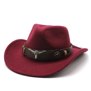 Detail of burgundy wool western cowboy hat featuring silver bull head on leather band