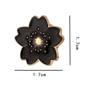 Detail showing a 1.7cm black and gold cherry blossom brooch with enamel finish