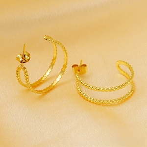 Detail of 18K gold plated double layer hoop earrings with beaded texture on silk
