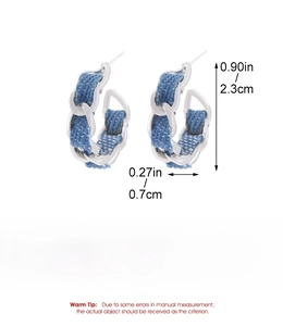 Detailed view of denim texture C-shape earrings with size dimensions 2.3cm by 0.7cm