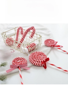 Close-up of red and white velvet Christmas ornaments including candy canes and lollipops