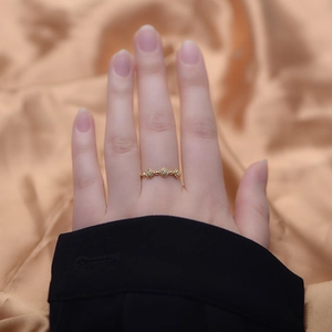 Detail of delicate gold rose ring featuring three floral motifs with sparkling zircons
