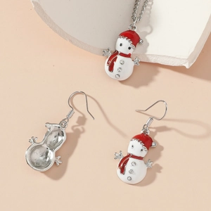Macro view of snowman necklace and earrings set with red enamel and crystals