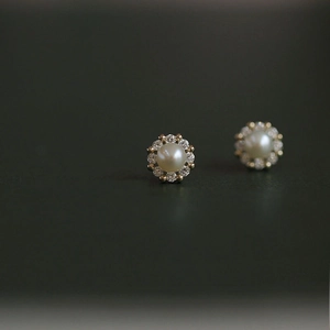 Elegant floral pearl stud earrings with gold plating and cubic zirconia crystals