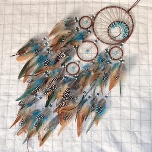 Bohemian dream catcher with turquoise tree of life design and colorful natural feathers