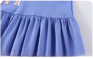 Détail de l'ourlet de la robe en tricot bleu lilas avec des plis artistiques délicats