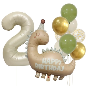 Detail of cream number 2 and dinosaur foil balloons set for birthday party decorations