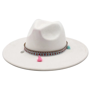 Detail of white wide brim fedora featuring tribal bands, charms and colorful tassels