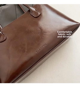 Close-up of dark brown tote bag in soft oil wax leather with Clearck embossed logo