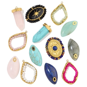 Detailed flat lay of water-drop natural stone pendants with gold plated stainless steel