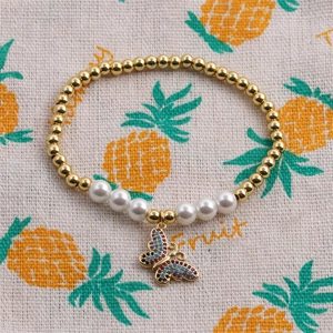 Chic beaded bracelet with golden beads, white pearls and a colorful zircon butterfly charm