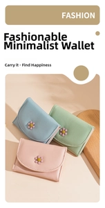 Detail of trifold wallets with daisy ornaments in pastel blue, green and pink colors