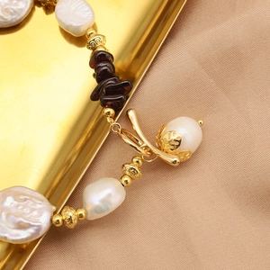 Baroque natural pearl bracelet with deep purple garnets and golden retro clasp accents