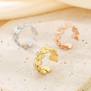 Detailed view of woven leaf texture open rings in gold, silver, and rose gold