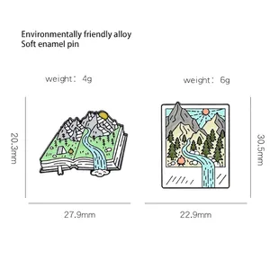 Outdoor nature enamel pins set featuring mountain scenery inside book and camera frames