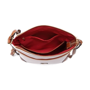 Detailed interior of pebbled leather crossbody bag with red lining and golden zipper