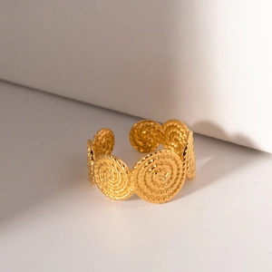 Adjustable gold spiral band ring with textured circular vortex patterns for women