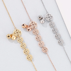 Detailed view of stainless steel coin and bell anklets in gold, rose gold, and silver finishes