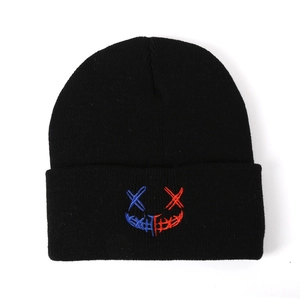 Minimalist black knit beanie with red and blue embroidered smile face for street style