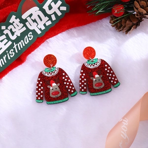 Close-up of festive red glitter sweater earrings with reindeer and snowflake patterns
