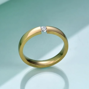 Detail of 3mm gold stainless steel ring featuring a centered sparkling round cut diamond