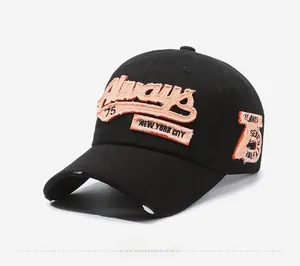Close-up of vintage black baseball cap with orange towel embroidery and distressed brim