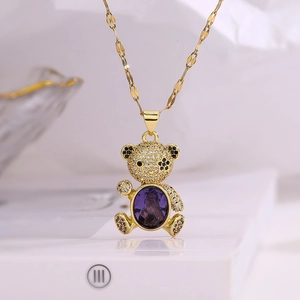 Gold-plated bear pendant necklace featuring purple gemstone and sparkling zircon crystals