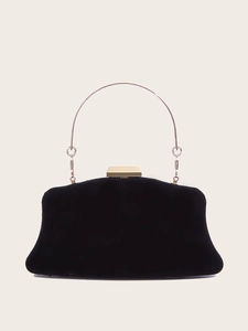 Close-up of black suede evening clutch with gold metal round handle and geometric clasp