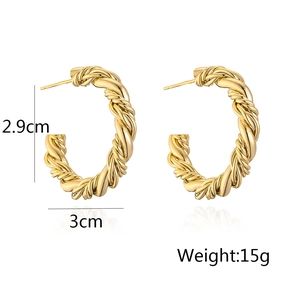 Detail view of twisted gold-plated C-shape hoop earrings with 2.9cm and 3cm dimensions