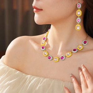 Close-up of vintage-style jewelry set with tassel earrings and necklace on model