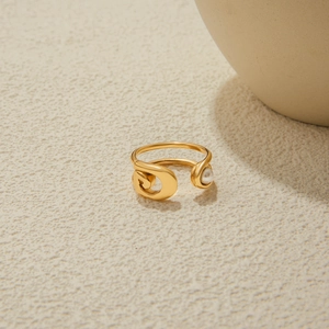 Detail of 18K gold plated stainless steel paperclip ring with white pearl accent